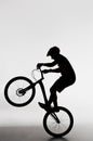 silhouette of trial biker standing on back wheel Royalty Free Stock Photo