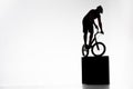 silhouette of trial cyclist balancing on obstacles