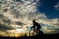 Silhouette of a triathlete in sunset