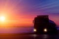 Silhouette Truck with container on highway, cargo transportation concept. Sunset background with copy space