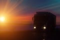 Silhouette Truck with container on highway, cargo transportation concept. Sunset background with copy space