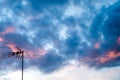 Silhouette of a tv antenna with the colorful sky on the backround