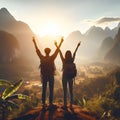 Silhouette of two backpackers raising their hands up in the mountains Royalty Free Stock Photo