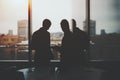 Silhouette of two businessmen in office interior Royalty Free Stock Photo