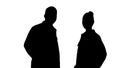 Silhouette Two caucasian and afro american smiling doctors stand