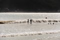 A silhouette of two children playing at the beach