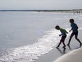 Silhouette of two children on beach