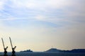 Silhouette of two cranes in the sunset light  with profile of the Frioul islands in the background Royalty Free Stock Photo