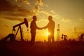 Silhouette of two engineers handshaking in front of oil pump. Generative AI Royalty Free Stock Photo