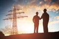Two Engineers Shaking Hands Against Dramatic Sky Royalty Free Stock Photo
