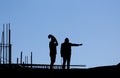 Silhouette of construction workers on building site