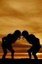 Silhouette of two football players in the sunset stand Royalty Free Stock Photo