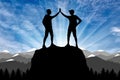 Silhouette of two happy climber conquered the top. Royalty Free Stock Photo