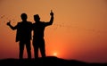 Silhouette of two happy people at sunset Royalty Free Stock Photo