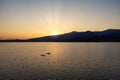 Silhouette of Two kajaks in the middle of the lake at sunset Royalty Free Stock Photo