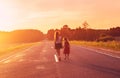 Silhouette two little girls walking on the road . Sisters enjoyed a Holiday over blurred summer nature. Concept People and nature.