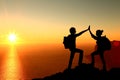 Silhouette of two man with success gesture standing on the top of mountain Royalty Free Stock Photo