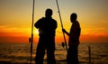 A silhouette of two men fishing Royalty Free Stock Photo