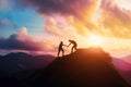 Silhouette two people helping each other hike up a mountain at sunrise or sunset. Giving a helping hand. Travel hiking journey Royalty Free Stock Photo