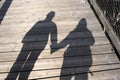 silhouette of two people holding their hands