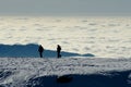 Two people silhouette on the snow