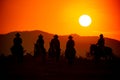 Silhouette of two western riders against amber colored sunset Royalty Free Stock Photo