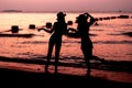 Silhouette of two woman having fun on the sea beach Royalty Free Stock Photo