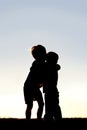 Silhouette of Two Young Children Hugging at Sunset Royalty Free Stock Photo