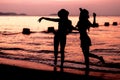 Silhouette of two woman having fun on the sea beach Royalty Free Stock Photo