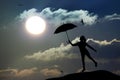 Silhouette of umbrella woman jump and sunset with big sun, Royalty Free Stock Photo