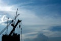 Silhouette under construction high-rise condominium building real estate property industry with hoisting cranes in blue morning Royalty Free Stock Photo