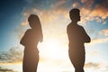 Silhouette Of A Unhappy Couple Standing Back To Back Royalty Free Stock Photo