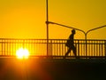 Silhouette of unknown city people walking across the overpass Flyover