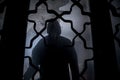 Silhouette of an unknown shadow figure on a door through a closed glass door. The silhouette of a human in front of a window at