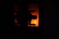 Silhouette of an unknown shadow figure on a door through a closed glass door. The silhouette of a human in front of a window at