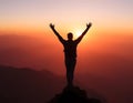 A silhouette of a victorious hiker standing on a mountain peak Royalty Free Stock Photo