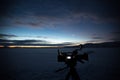 Silhouette of video camera on background of Siberian sunset.