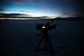 Silhouette of video camera on background of Siberian sunset.