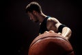 Silhouette view of a basketball player holding basket ball on black background Royalty Free Stock Photo