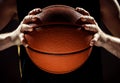 Silhouette view of a basketball player holding basket ball on black background Royalty Free Stock Photo