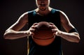 Silhouette view of a basketball player holding basket ball on black background