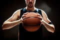 Silhouette view of a basketball player holding basket ball on black background Royalty Free Stock Photo