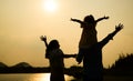 Silhouette view of happy family relaxing in park together on weekend Royalty Free Stock Photo