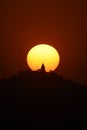 A silhouette view of Sunset on hill area and temple in front Royalty Free Stock Photo