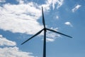 Silhouette view of a wind turbine over a blue cloudy sky Royalty Free Stock Photo