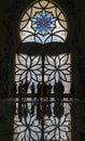 Silhouette of viistors in Shaikh Zayed Grand Mosque with dark background of a door with islamic art decoration