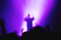 Silhouette of a vocalist of a musical group on stage in the light of spotlights