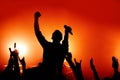 Silhouette of a vocalist performing at a rock concert among fans