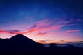 Silhouette of volcano del Teide against a sunset sky. Pico del Teide mountain in El Teide National park at night.
