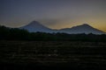 Landscape of volcanoes and field sunrise